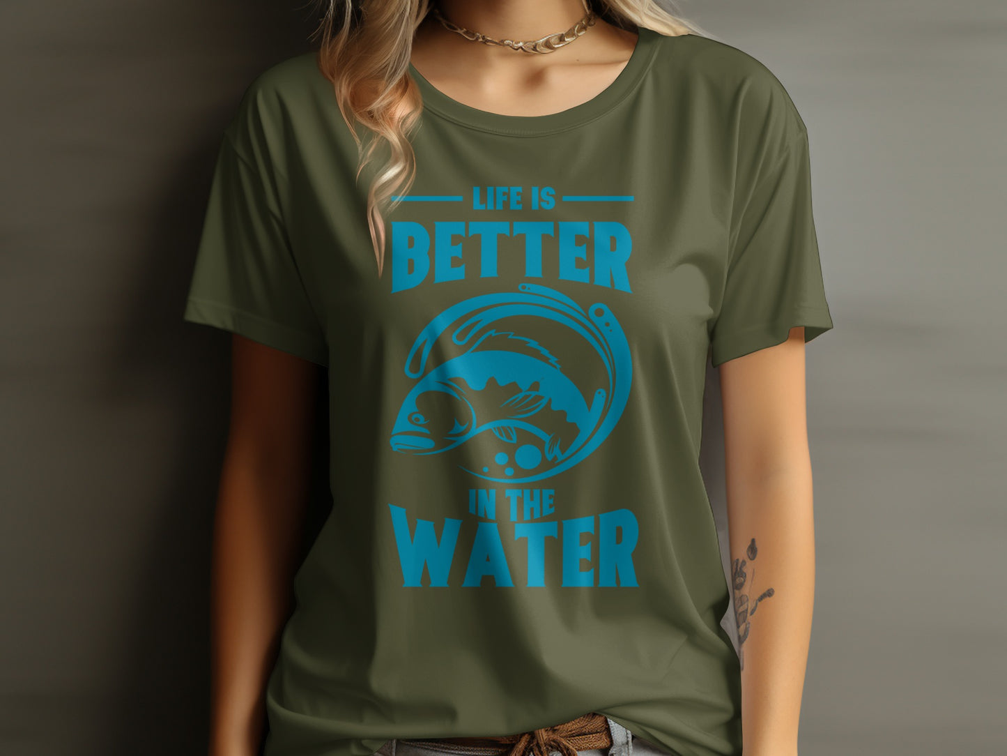 Olive green t-shirt with blue fish and text reading "LIFE IS BETTER IN THE WATER".