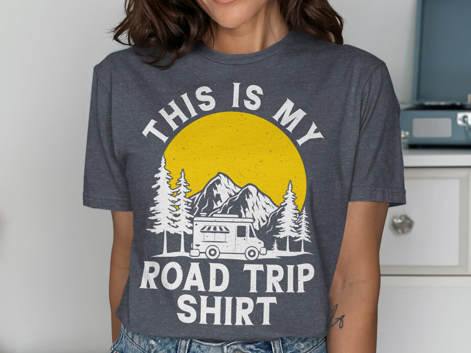 Dark gray t-shirt with "THIS IS MY ROAD TRIP SHIRT" and a mountain, camper, and sun graphic.