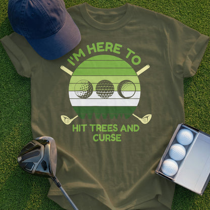 Olive green t-shirt with "I'm here to hit trees and curse" text and golf balls.