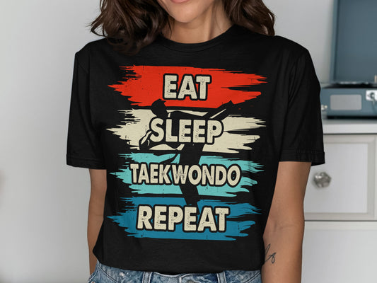 Black t-shirt with "Eat Sleep Taekwondo Repeat" and graphic of a taekwondo kick.