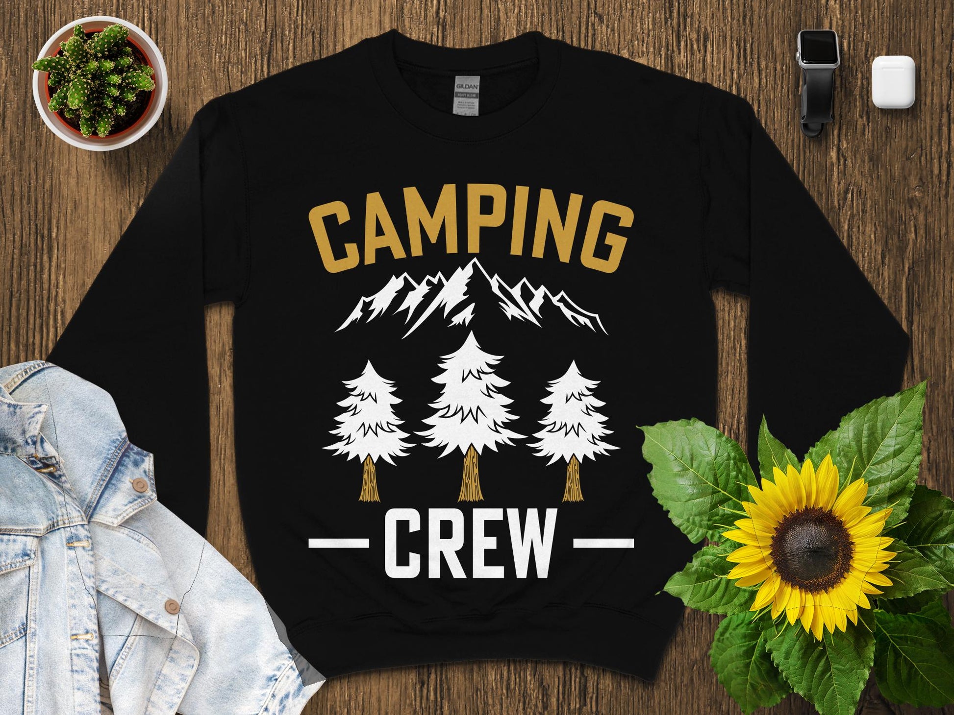 Black sweatshirt with "CAMPING CREW" text and mountain and tree graphics.