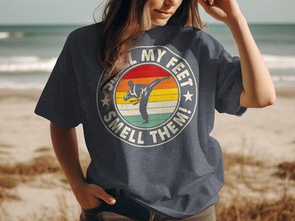 Circular graphic on t-shirt reads "My feet smell them!" with a karate kick graphic.