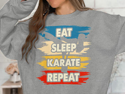 Gray sweatshirt with "Eat Sleep Karate Repeat" text and silhouette of a karate figure.