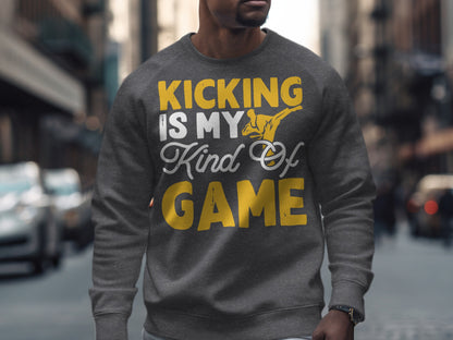 Gray sweatshirt with "Kicking is my kind of game" text and a kicking figure.