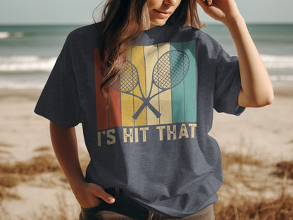 T-shirt with crossed tennis rackets and "I Hit That" text.
