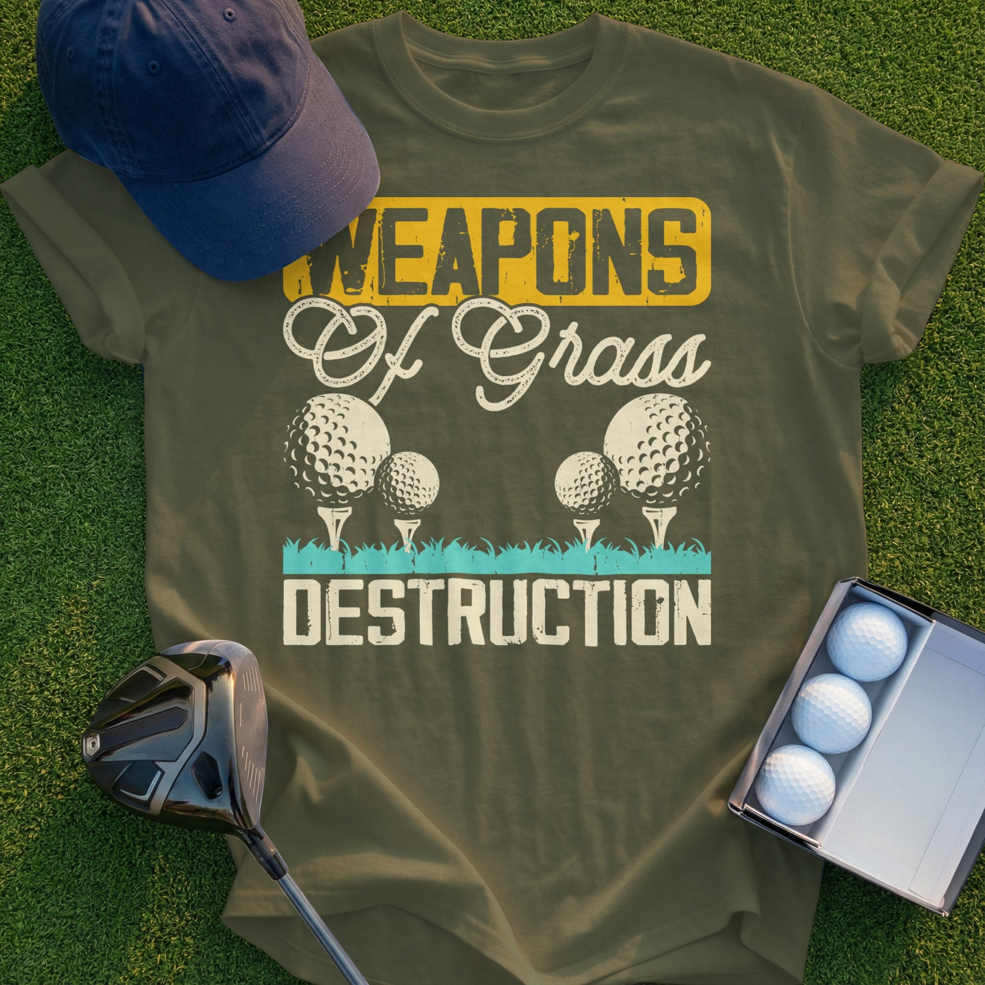 Olive green t-shirt with "Weapons of Grass Destruction" text and golf balls.