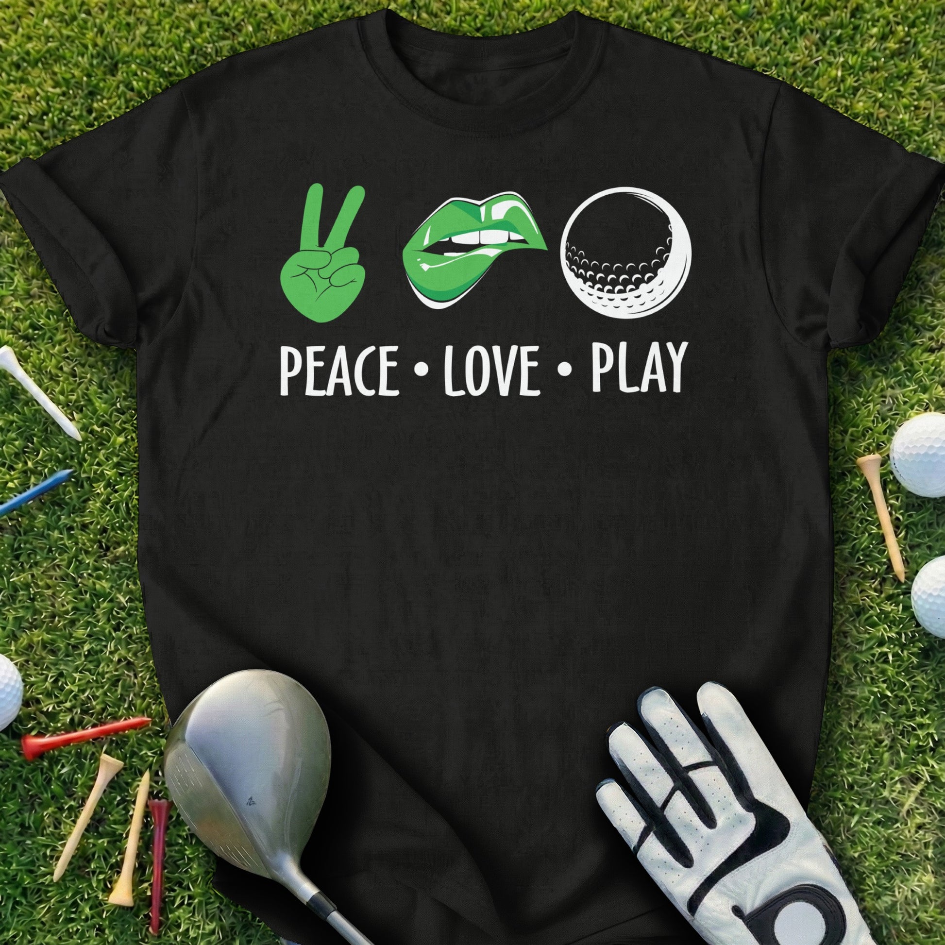 Black t-shirt with green peace sign, lips, and golf ball graphic, text reads "PEACE LOVE PLAY".