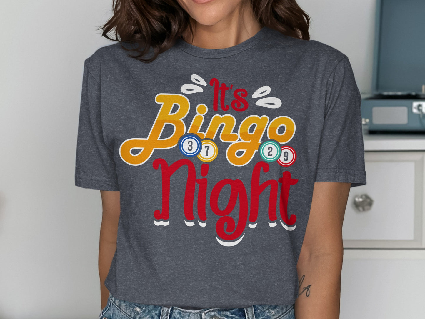 Dark grey t-shirt with "It's Bingo Night" in colorful lettering and numbers.