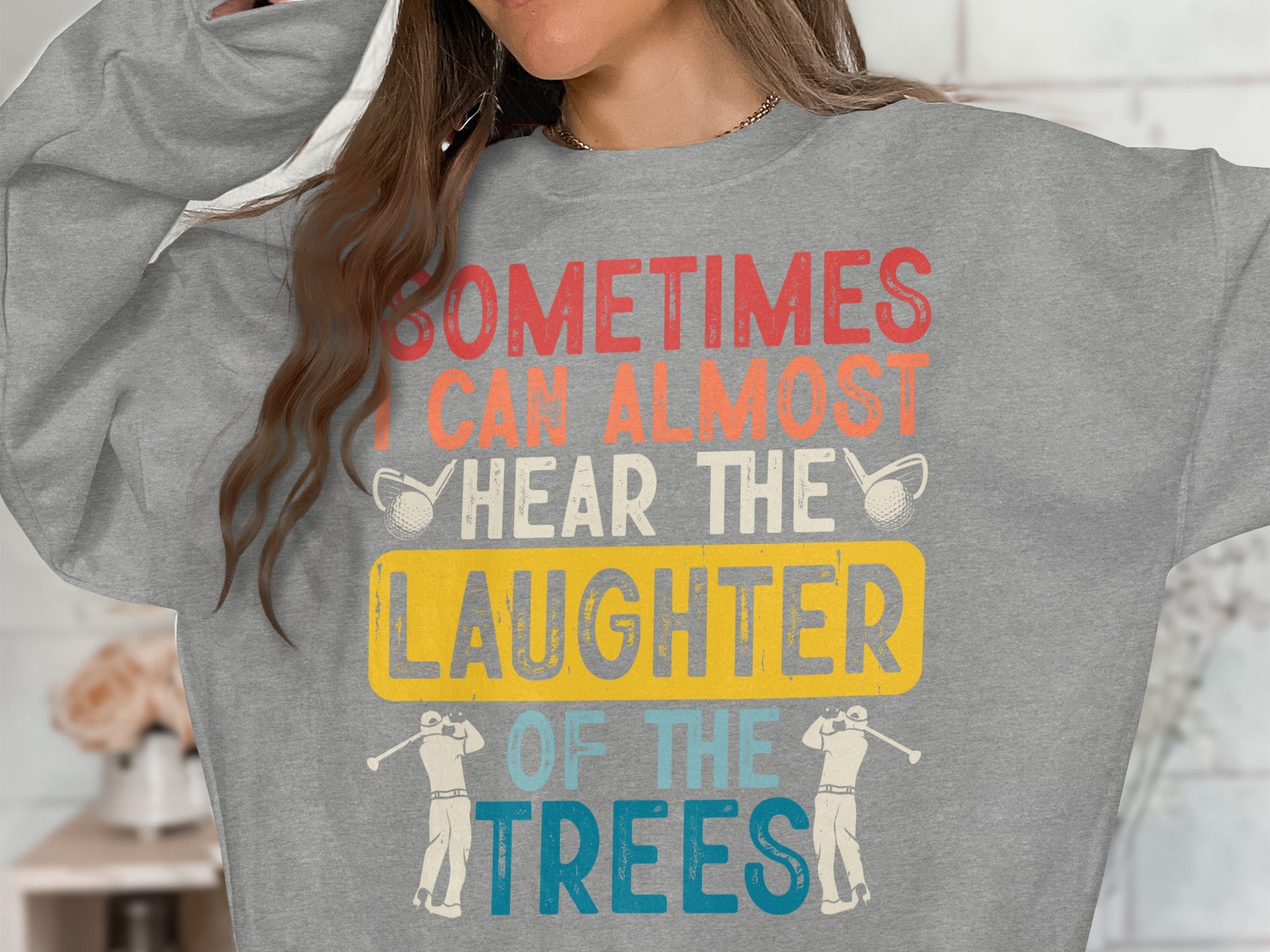 Grey sweatshirt with "Sometimes I can almost hear the laughter of the trees" text.