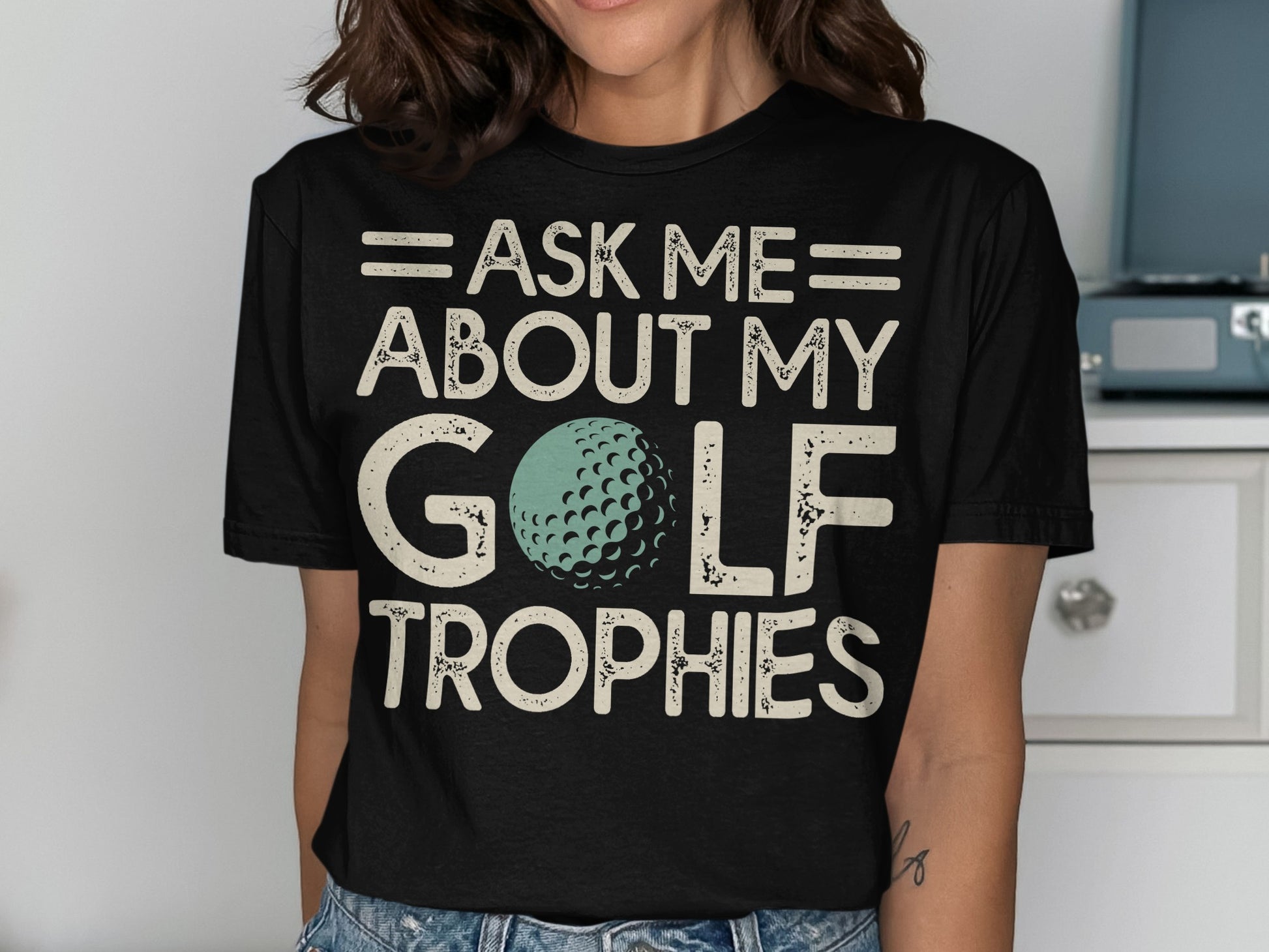 Black t-shirt with "Ask Me About My Golf Trophies" and a golf ball graphic.