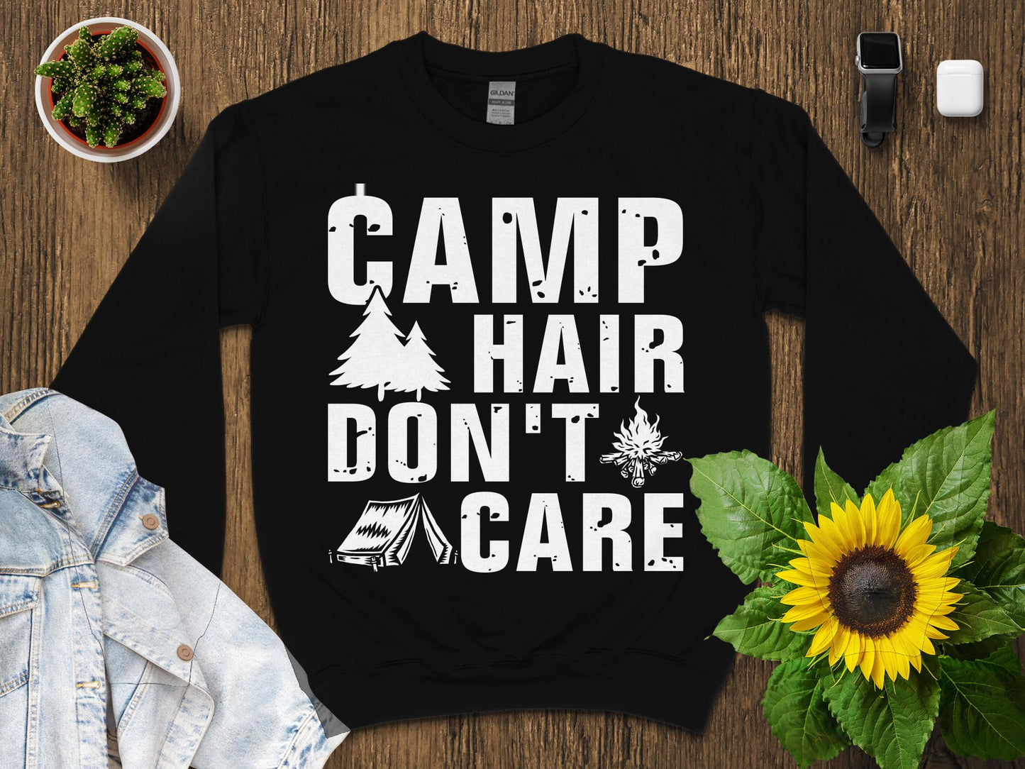 Black sweatshirt with "CAMP HAIR DON'T CARE" graphic and campfire icon.