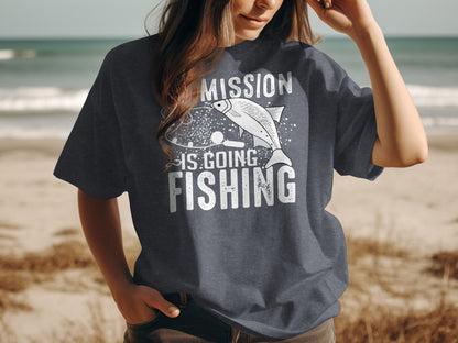 Woman wearing a dark t-shirt with "MISSION IS GOING FISHING" text and fish graphic.
