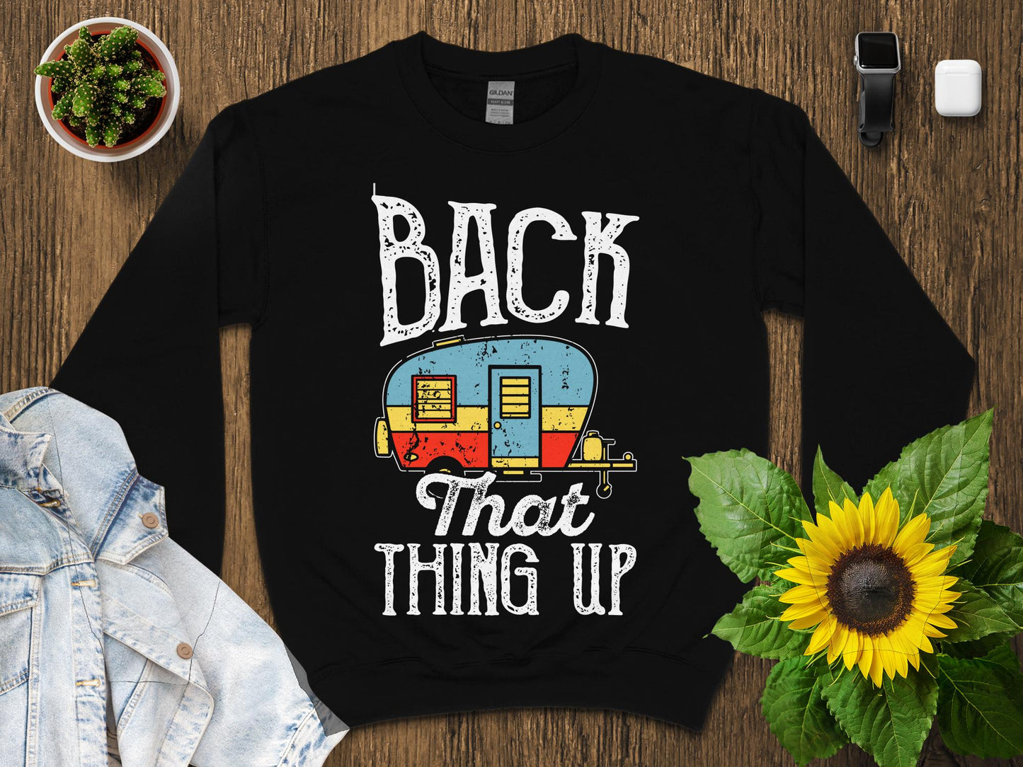 Black sweatshirt with "BACK THAT THING UP" text and vintage camper graphic.