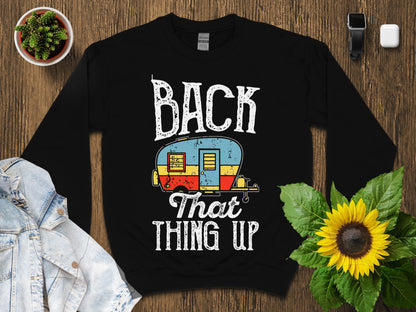 Black sweatshirt with "BACK THAT THING UP" text and vintage camper graphic.
