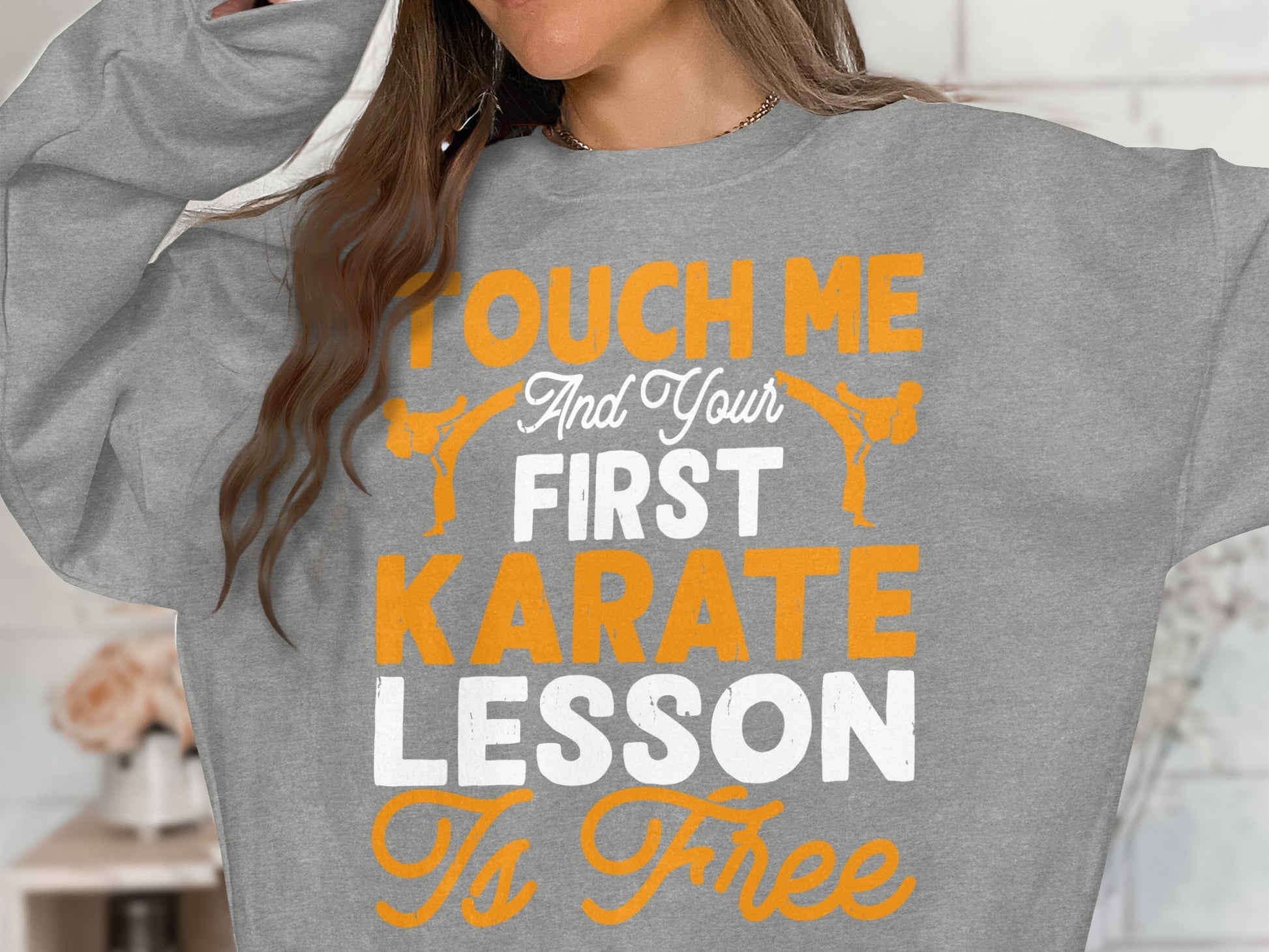 Gray sweatshirt with "Touch Me And Your First Karate Lesson Is Free" text and karate figures.