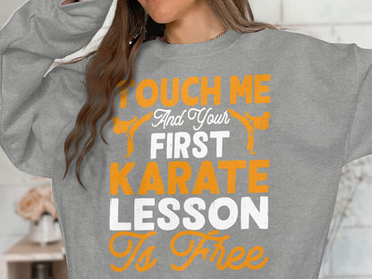 Gray sweatshirt with "Touch Me And Your First Karate Lesson Is Free" text and karate figures.