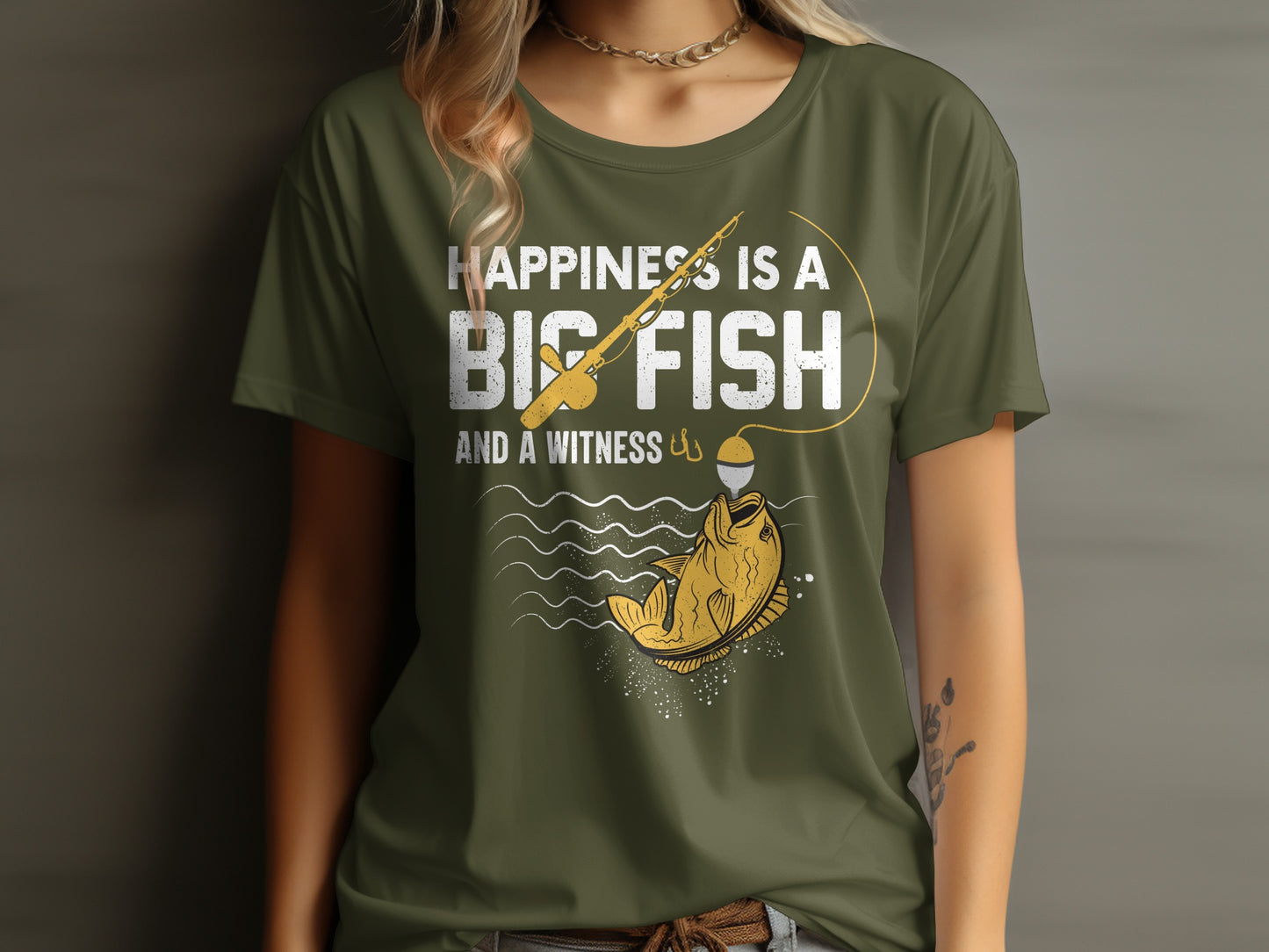 Green t-shirt with "Happiness is a big fish and a witness" fishing graphic.