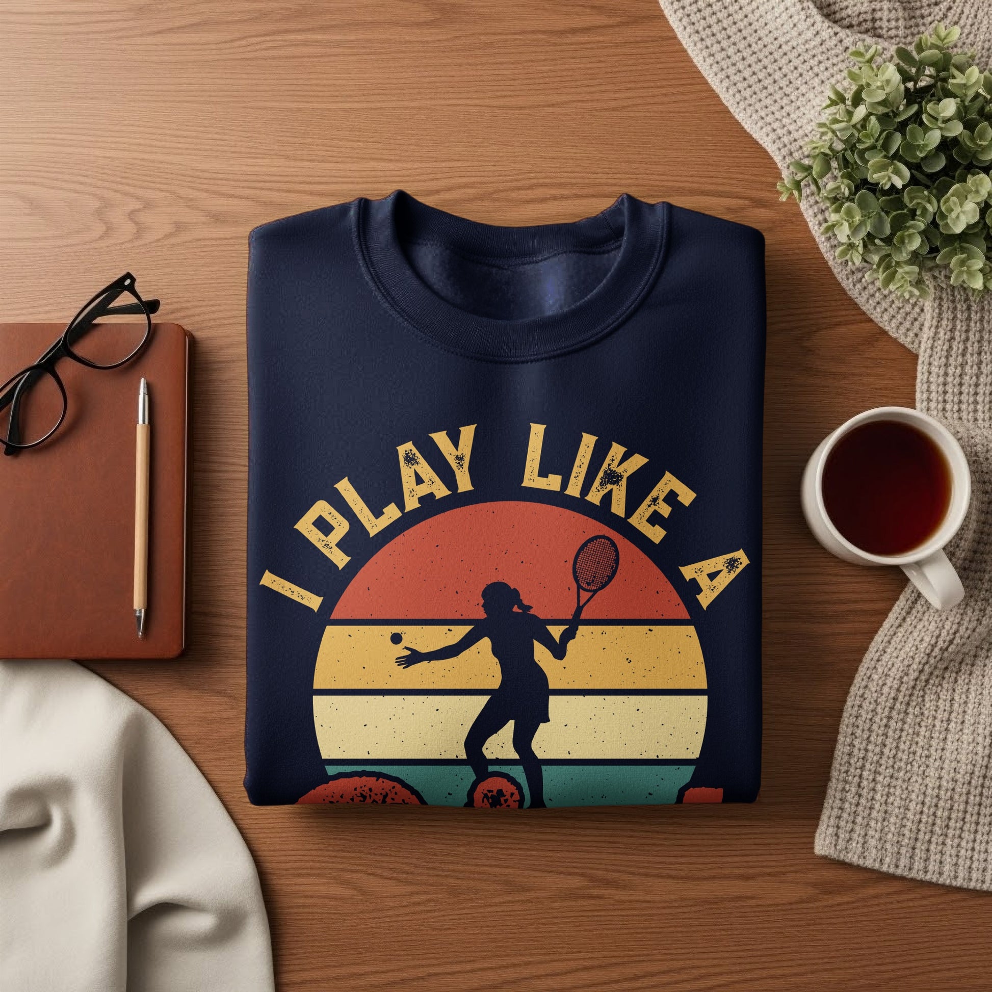 Navy sweatshirt with "I PLAY LIKE A" text and tennis player silhouette graphic.