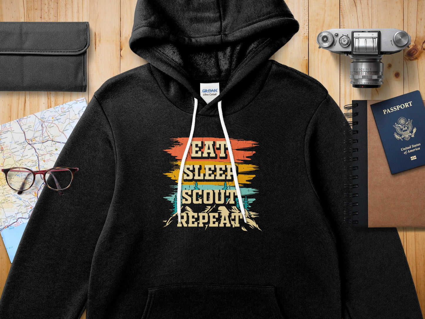 Black hoodie with "EAT SLEEP SCOUT REPEAT" text in colorful distressed lettering.