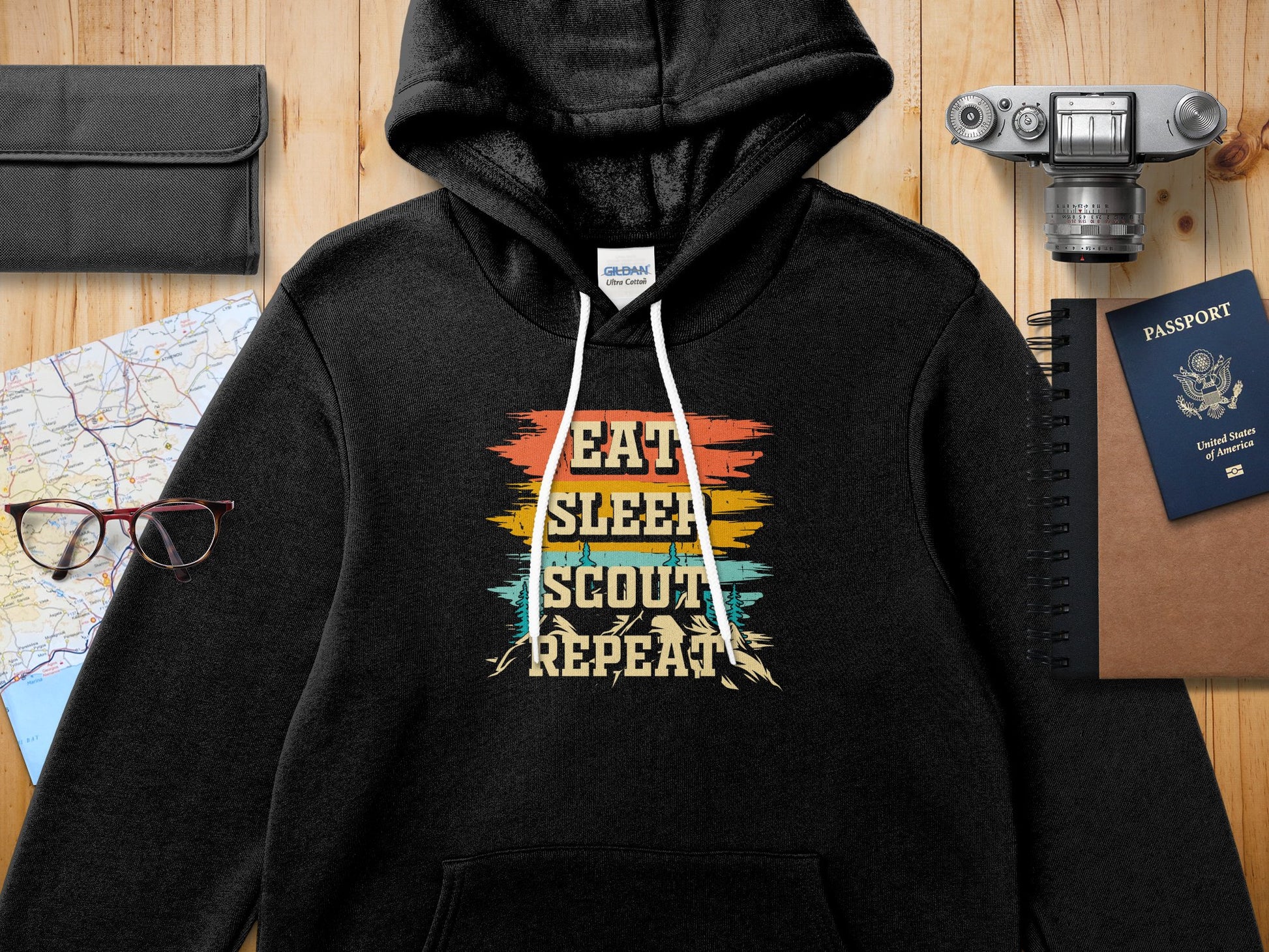 Black hoodie with "EAT SLEEP SCOUT REPEAT" text in colorful distressed lettering.