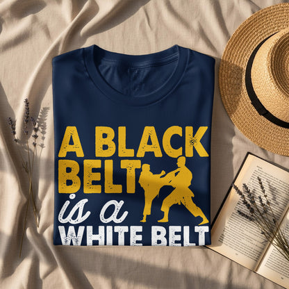 Navy t-shirt with yellow text "A Black Belt is a White Belt" and karate silhouette.