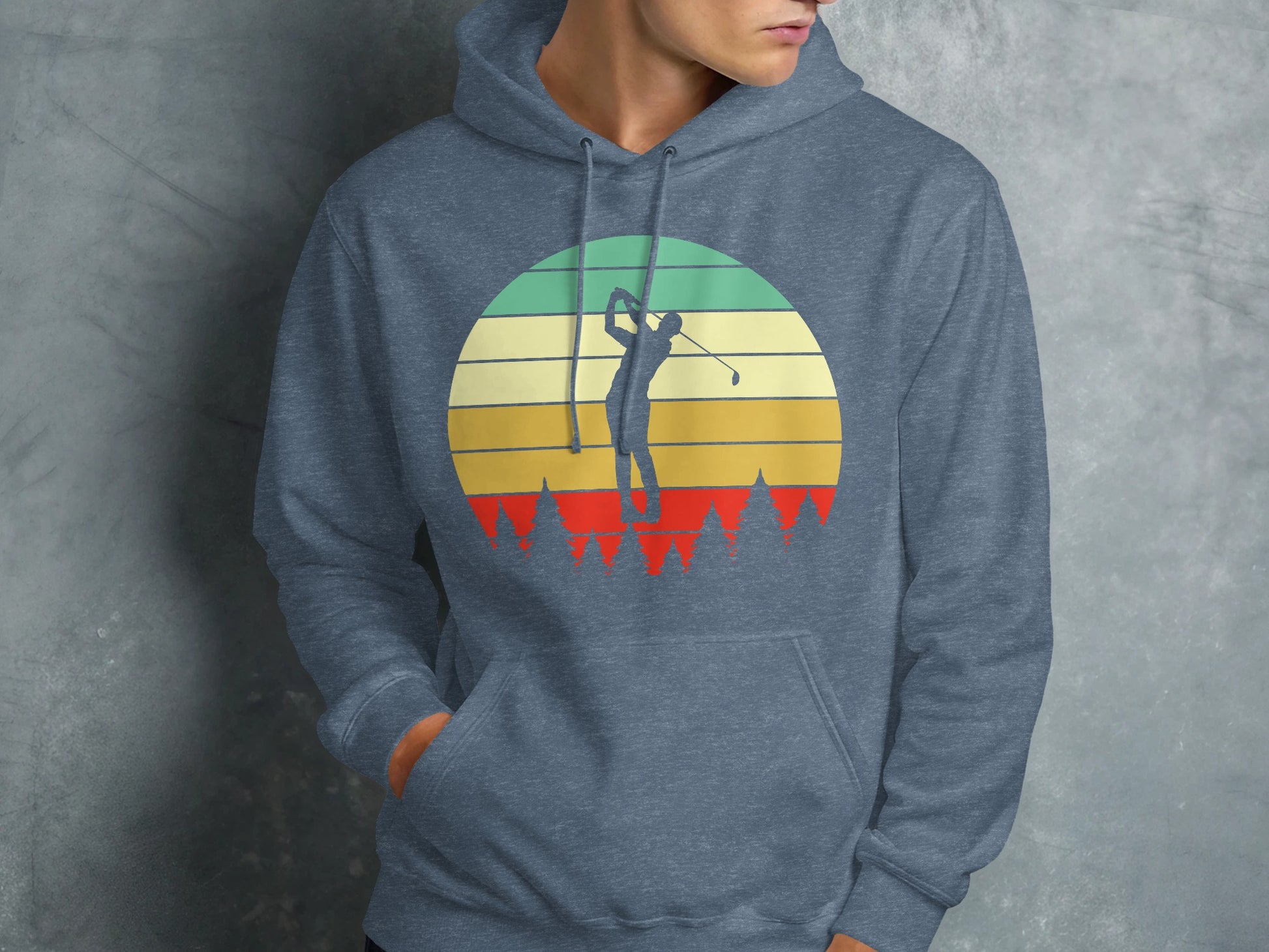 Man in blue hoodie with vintage golf sunset graphic.