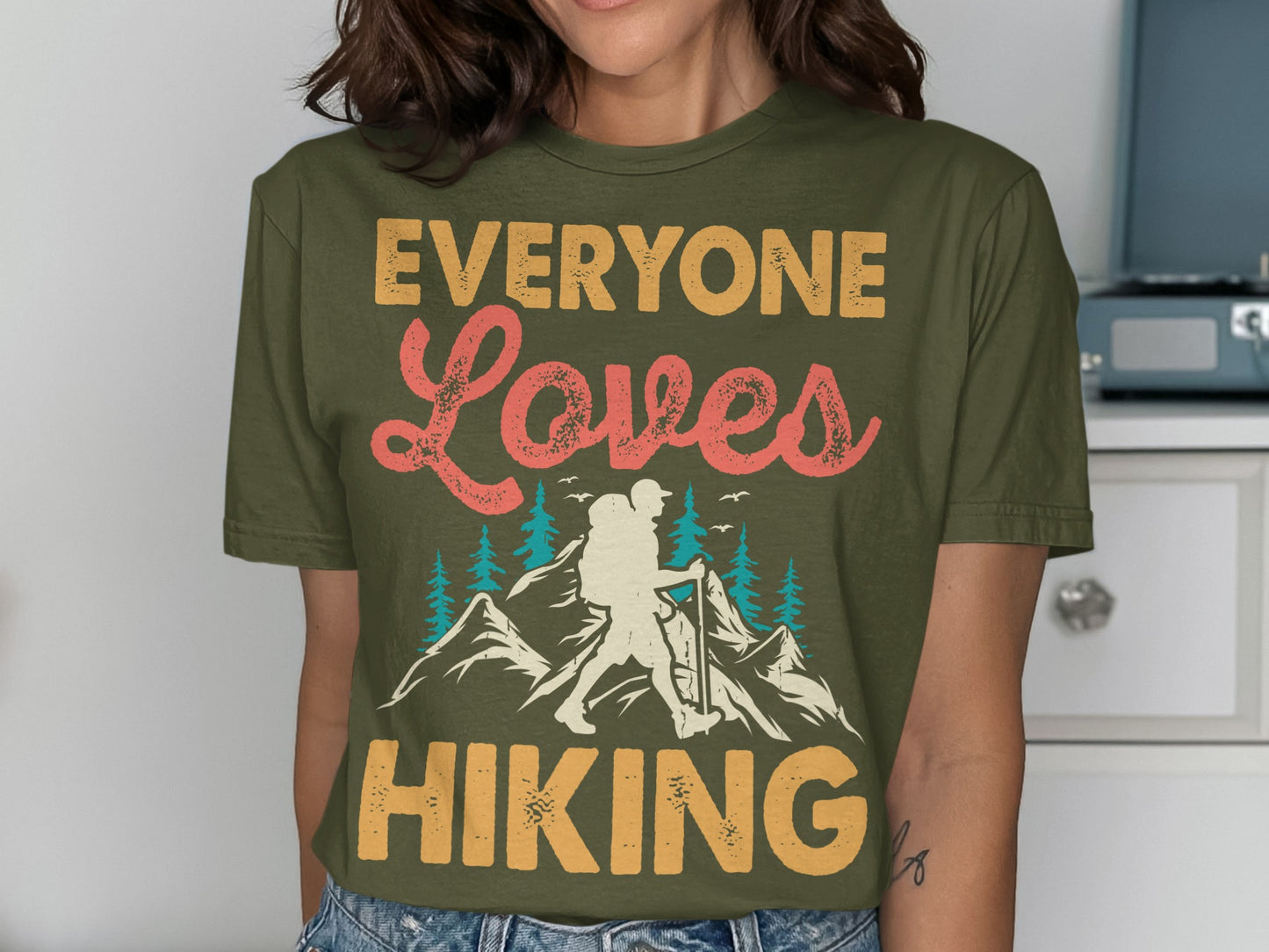 Olive green t-shirt with "EVERYONE Loves HIKING" text and mountain graphic.