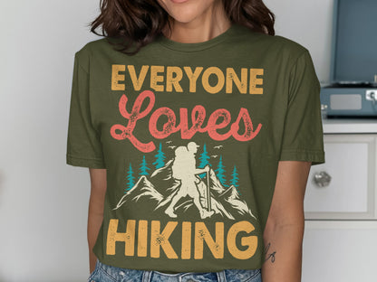 Olive green t-shirt with "EVERYONE Loves HIKING" text and mountain graphic.