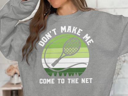 Grey sweatshirt with "DON'T MAKE ME COME TO THE NET" and tennis graphic.