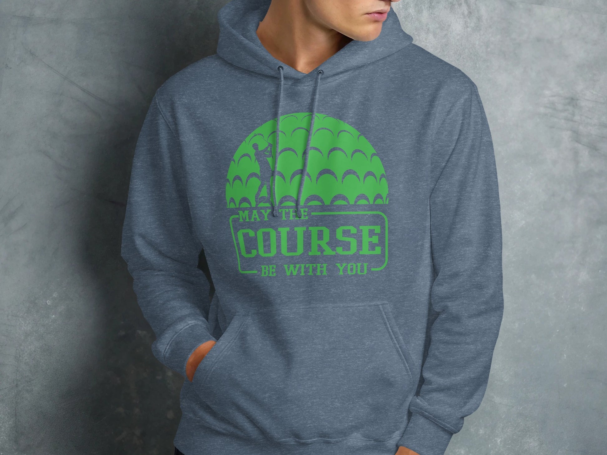 Green golf ball design on a gray hoodie that reads "MAY THE COURSE BE WITH YOU".