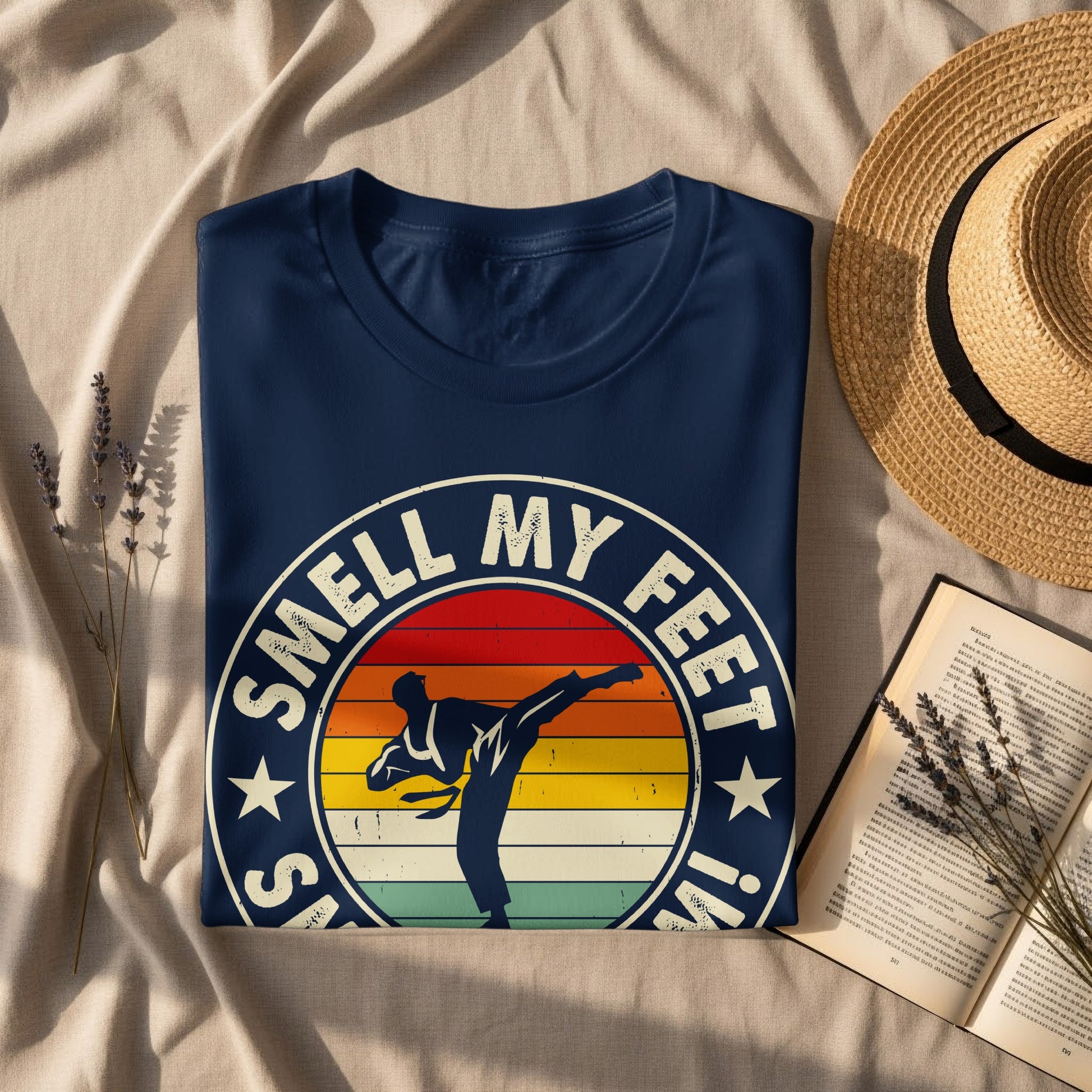 Navy t-shirt with "Smell My Feet!" text and a martial artist silhouette against a sunset.