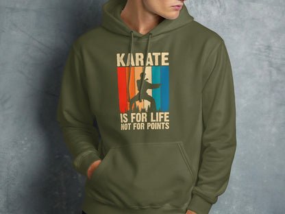 Olive green hoodie with "Karate is for life, not for points" text and sunset graphic.