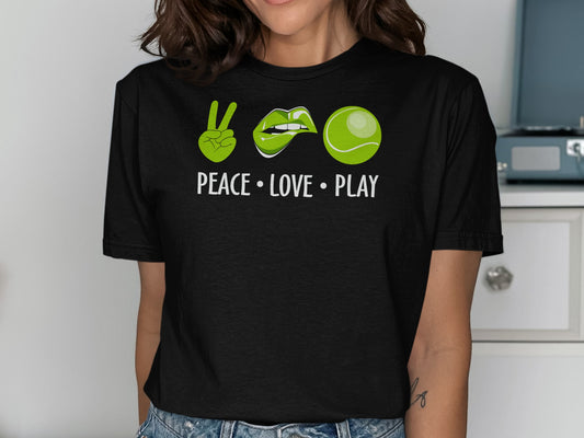 Black t-shirt with peace sign, lips, and tennis ball graphic and text.