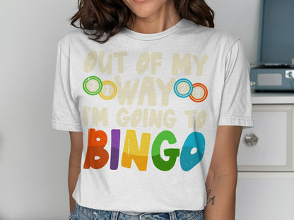 White t-shirt with "OUT OF MY WAY I'M GOING TO BINGO" in colorful letters.