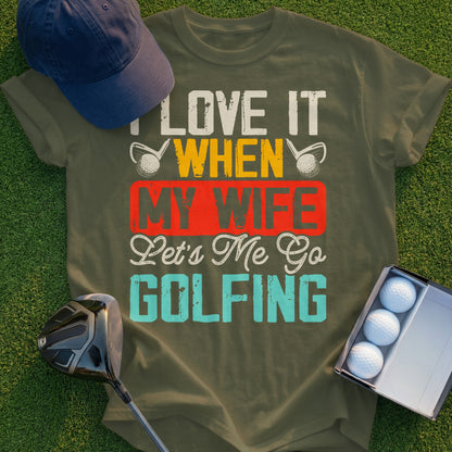 Olive green t-shirt with "I LOVE IT WHEN MY WIFE Lets Me Go GOLFING" text.