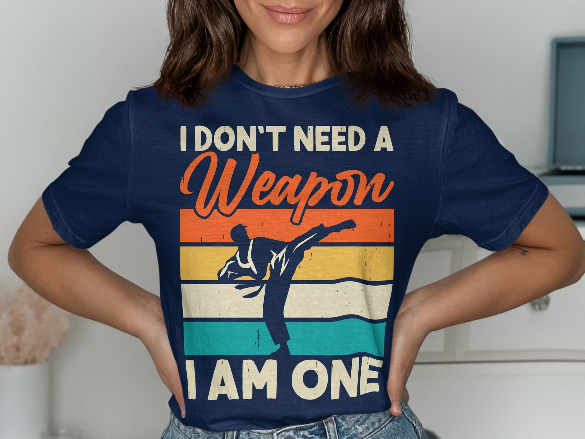 Navy t-shirt with martial artist silhouette and "I don't need a weapon I am one" text.