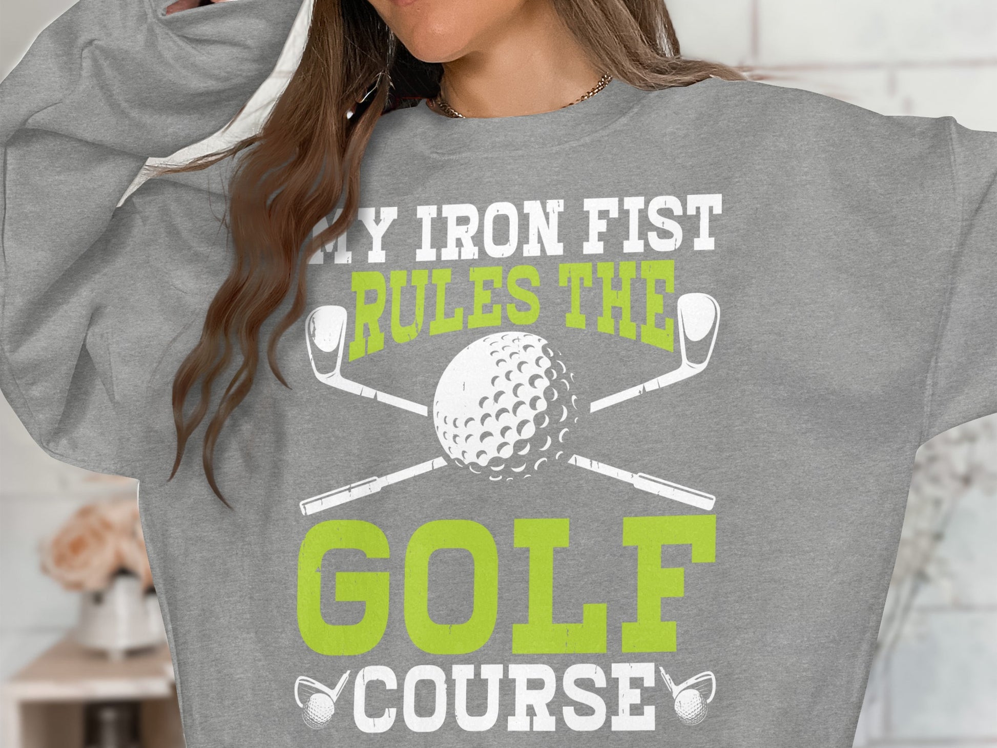 Gray sweatshirt with "My Iron Fist Rules The Golf Course" text and golf equipment.