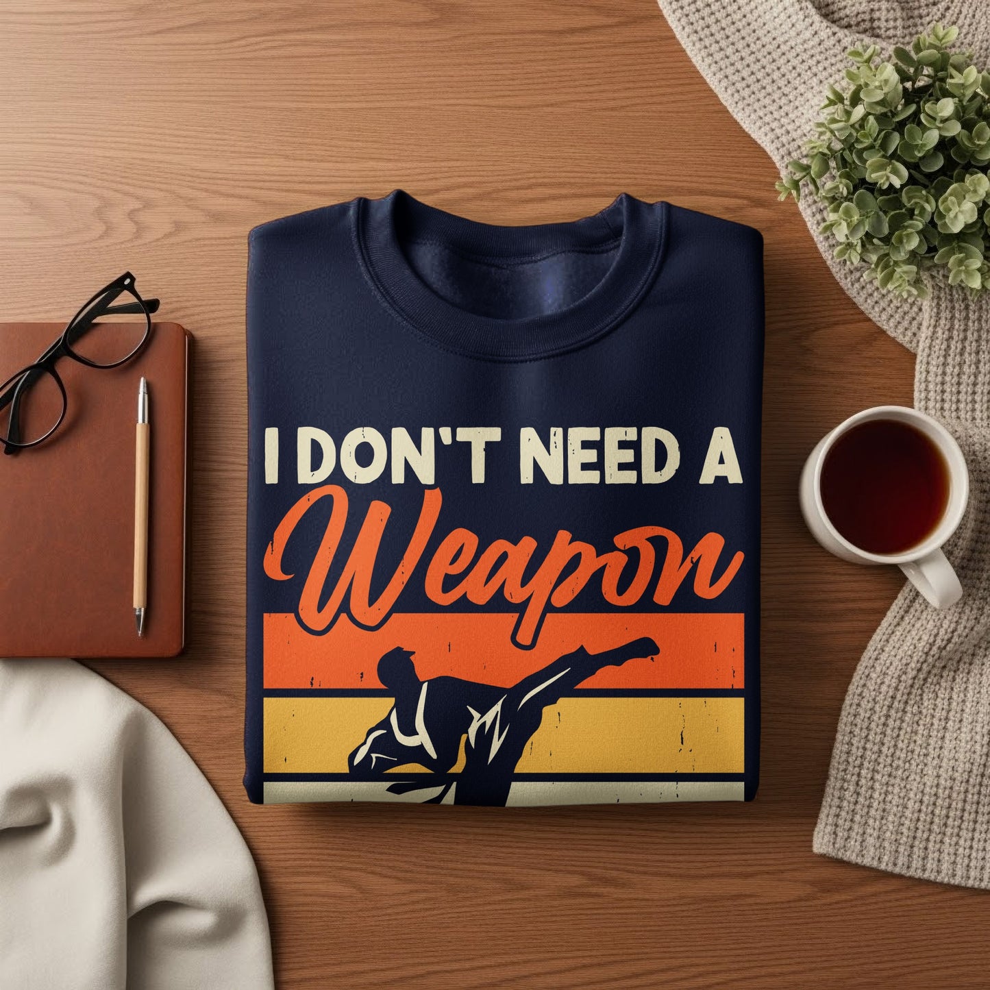 Dark blue sweatshirt with "I Don't Need A Weapon" and karate fighter graphic.