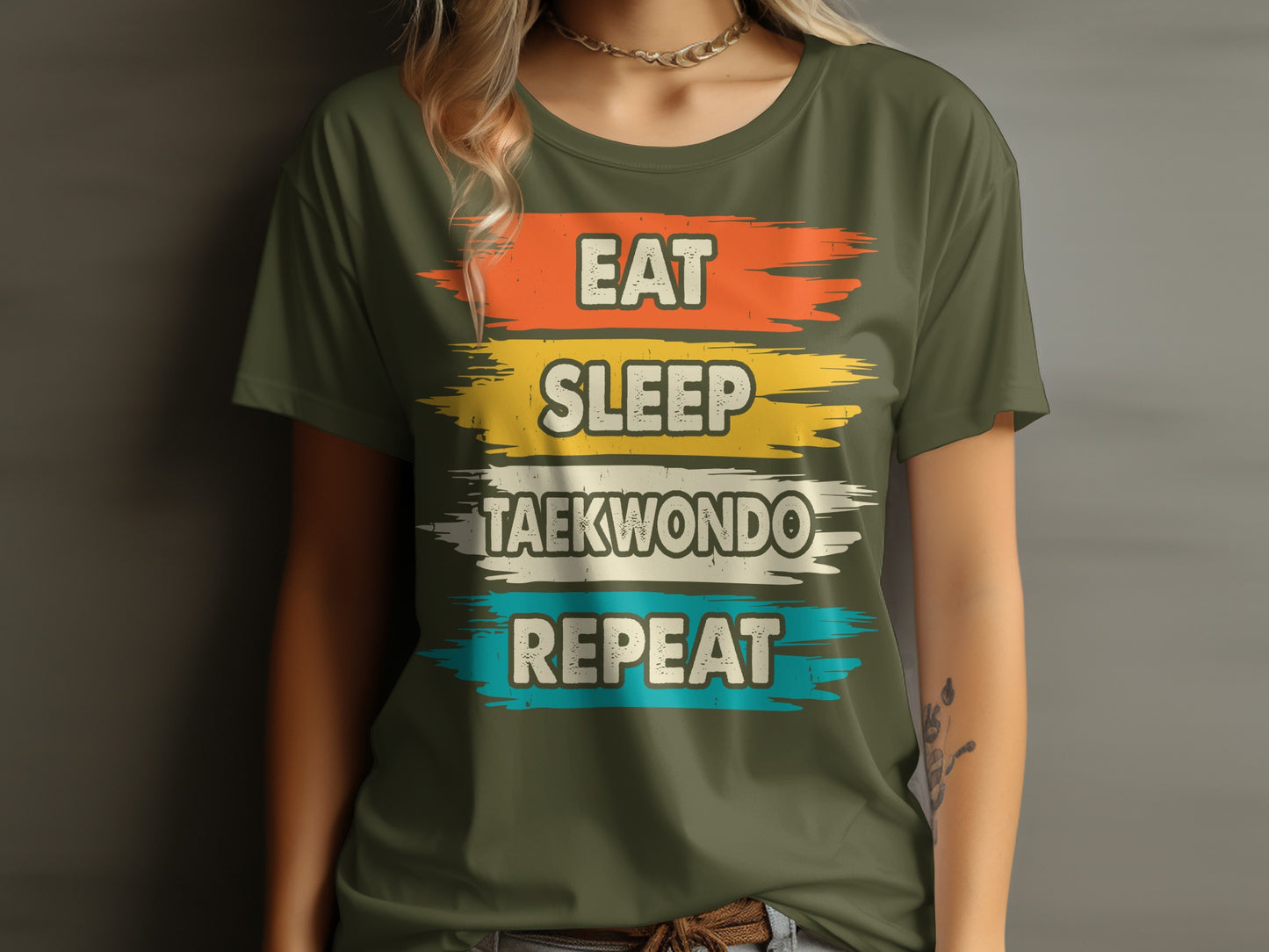 Green t-shirt with "Eat Sleep Taekwondo Repeat" text in colorful brushstrokes.