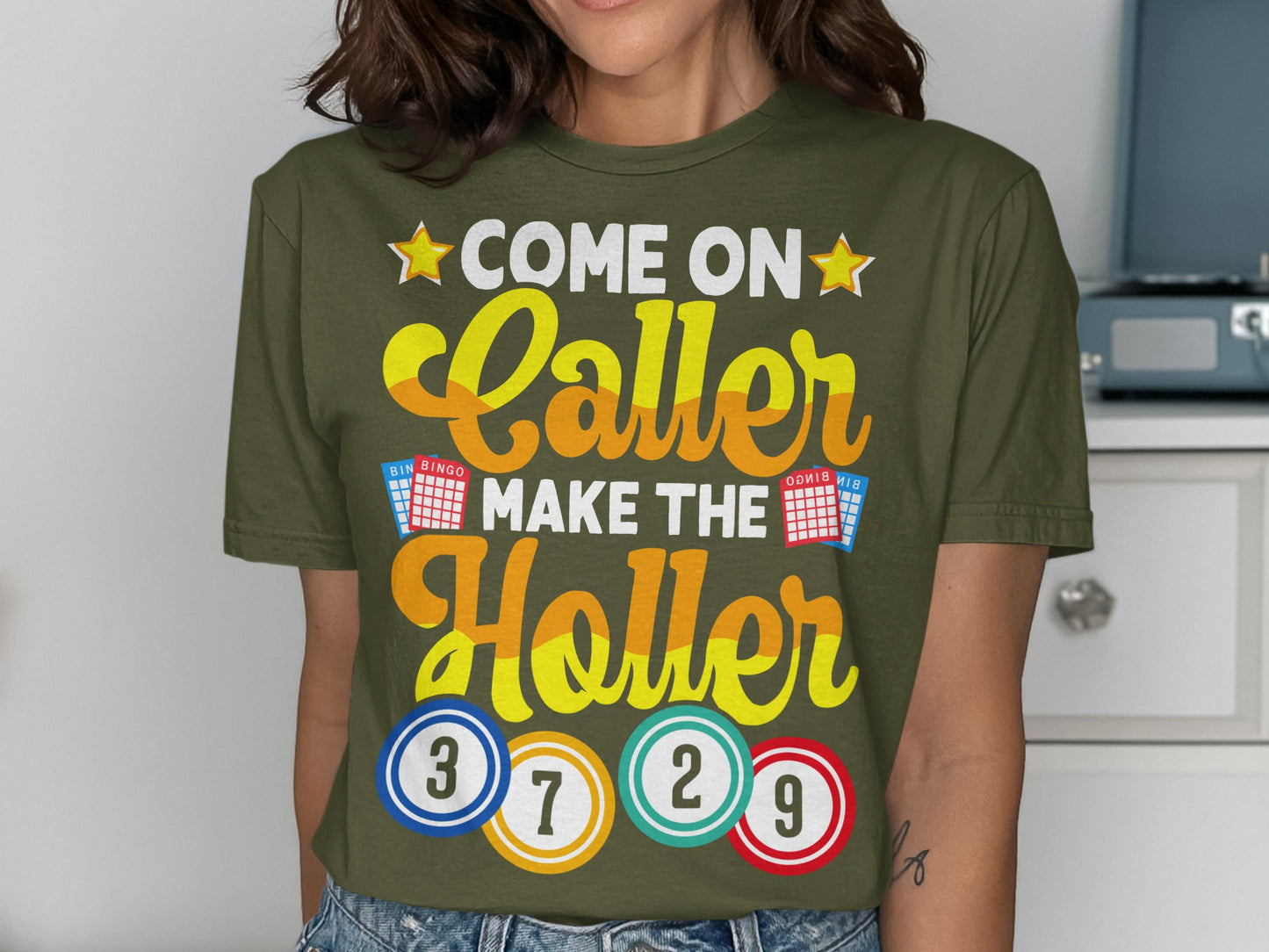 Green t-shirt with "Come on Caller Make the Holler" text and bingo balls.