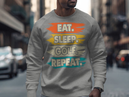 Gray sweatshirt with "Eat. Sleep. Golf. Repeat." text in brushstrokes.