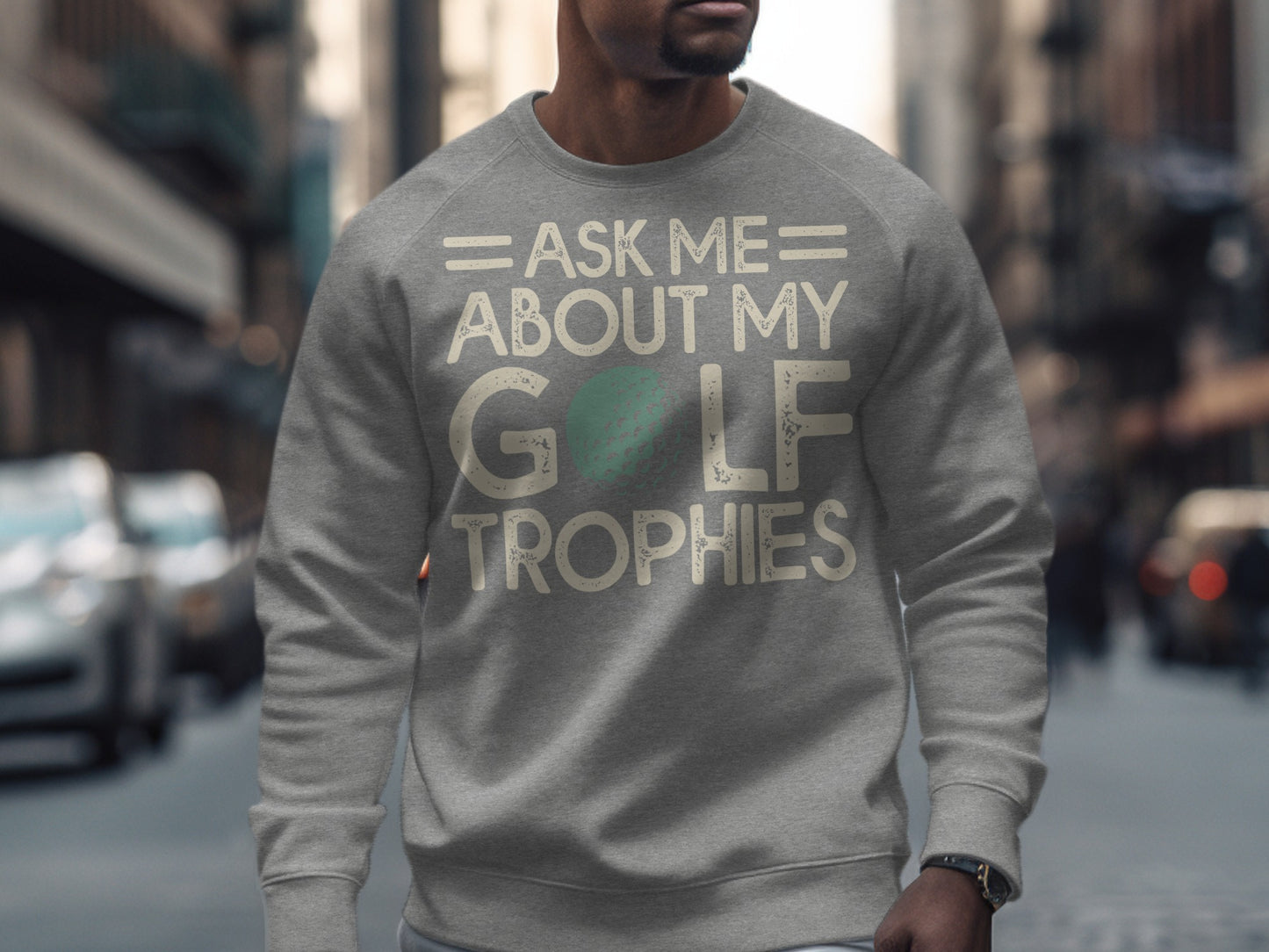 Grey sweatshirt with "Ask Me About My Golf Trophies" text and a golf ball graphic.