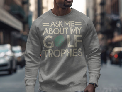 Grey sweatshirt with "Ask Me About My Golf Trophies" text and a golf ball graphic.