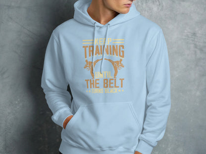 Light blue hoodie with text "Keep Training Until the Belt Turns Black".