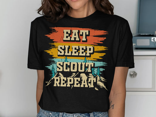 Black t-shirt with distressed "Eat Sleep Scout Repeat" text and mountain graphics.