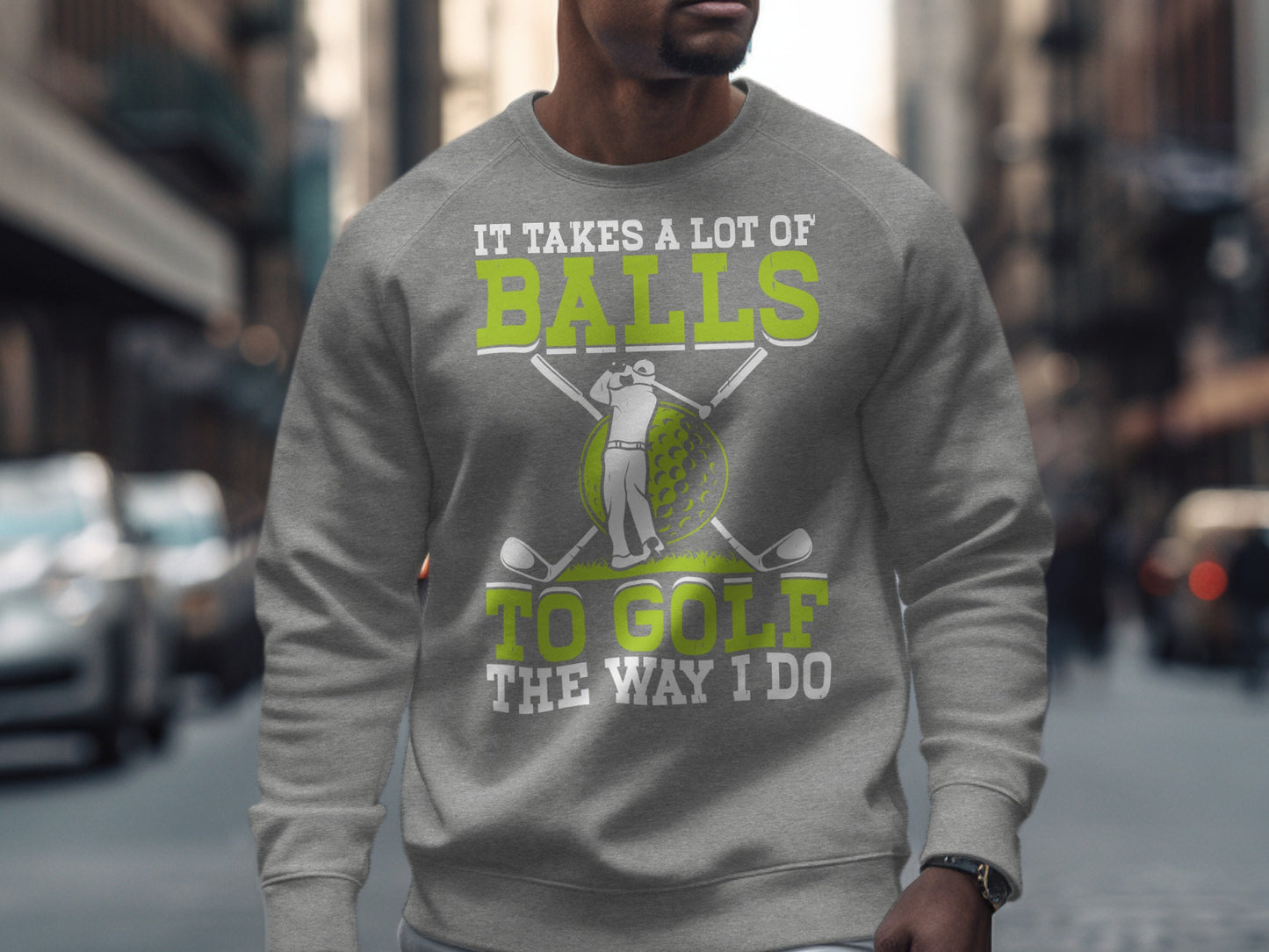 Gray sweatshirt with text "IT TAKES A LOT OF BALLS TO GOLF THE WAY I DO".