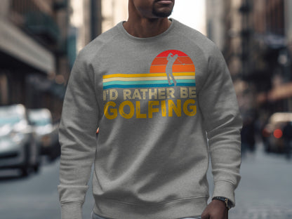Gray sweatshirt with "I'd Rather Be Golfing" text and sunset graphic.
