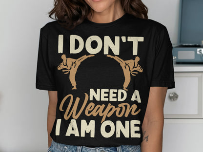 Black t-shirt with "I don't need a weapon I am one" and two taekwondo figures.