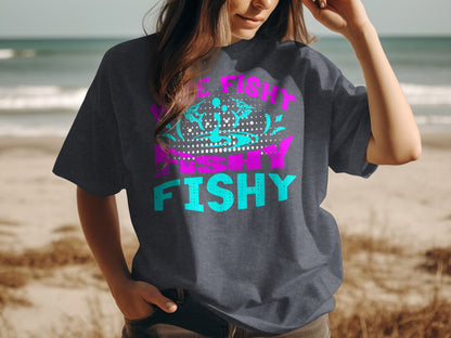 Dark t-shirt with neon pink and blue "Fishy Fishy" graphic.