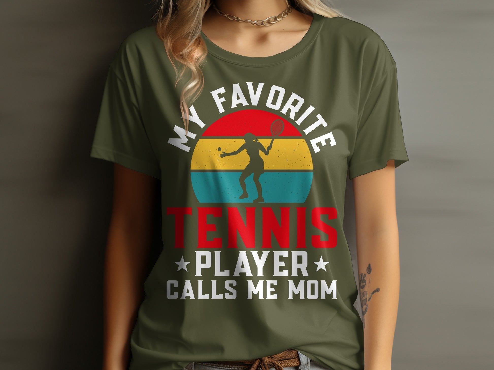 Green t-shirt with "My Favorite Tennis Player Calls Me Mom" text and graphic.